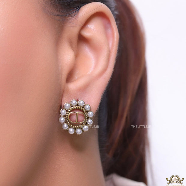 Gold plated round stud earrings with pearl lining and alphabets
