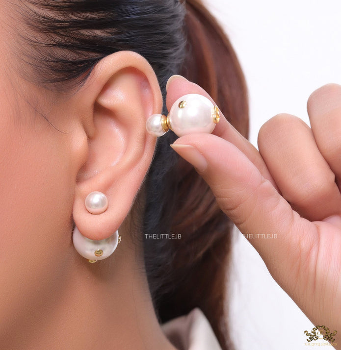 White pearl studs with golden alphabet motif and golden details