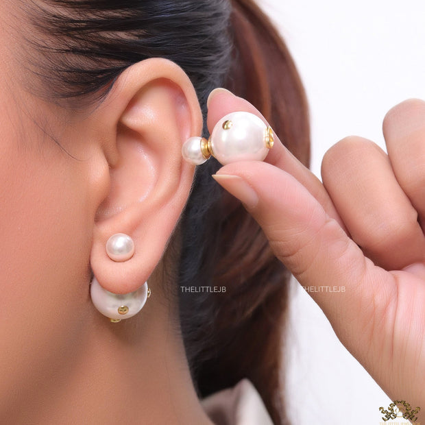 White pearl studs with golden alphabet motif and golden details