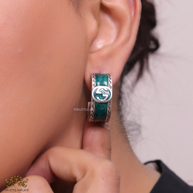 Blue green platinum studs with twin G motif