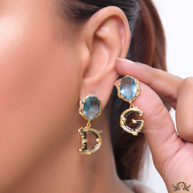 Semi-precious blue stone with gold plated detailed with black and golden alphabet drop