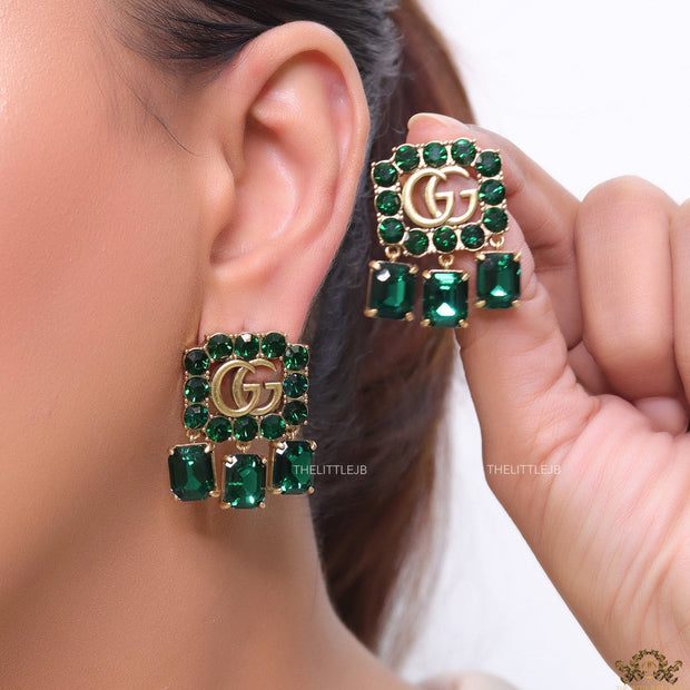 Emerald Green stone studs with gold plated double G motif and emerald green stone drop