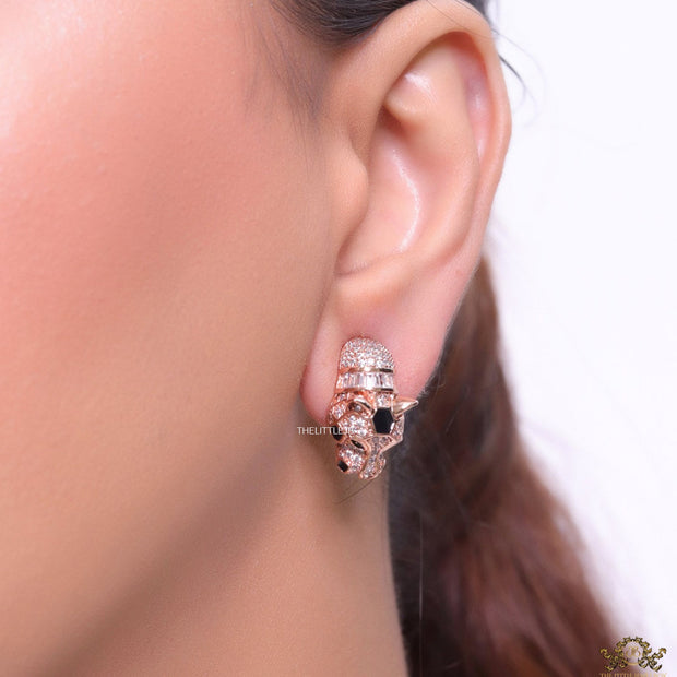 Asymmetrical cz and baguette panther studs in rose gold finish