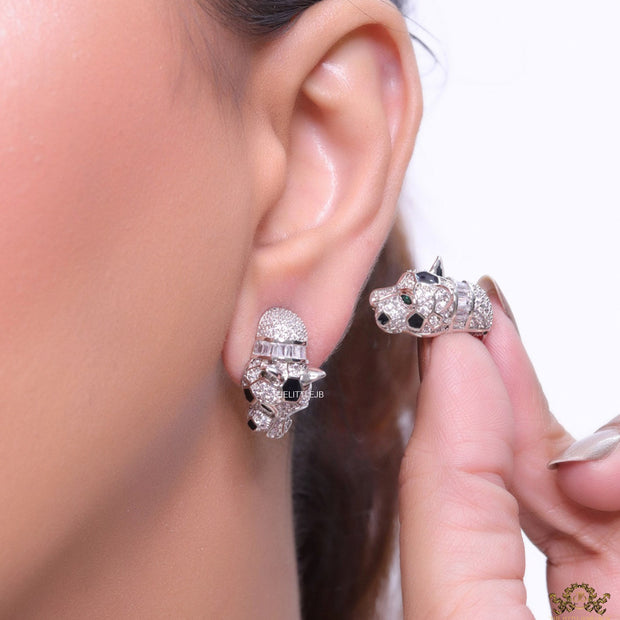 Asymmetrical cz and baguette panther studs in platinum finish