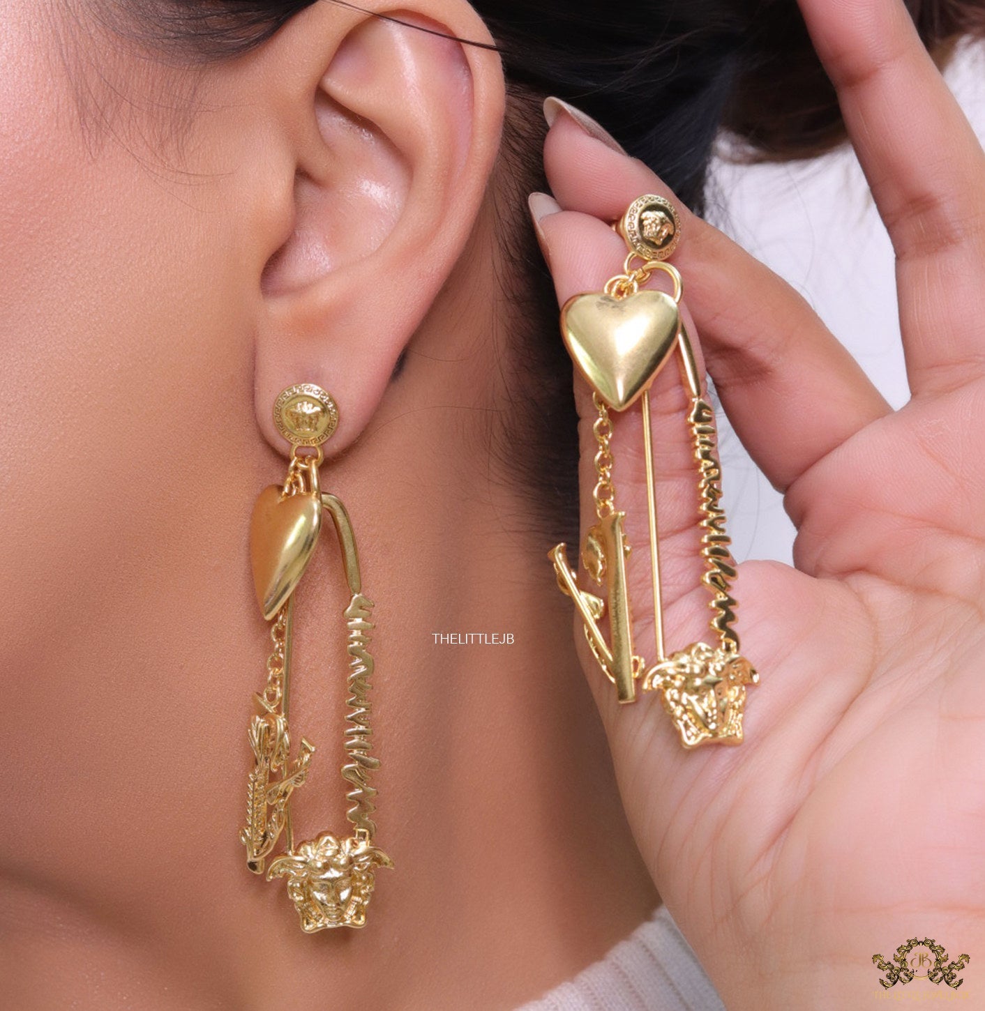 Unique golden Medusa earrings with safety pin motif