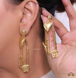 Unique golden Medusa earrings with safety pin motif