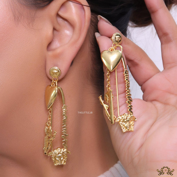 Unique golden Medusa earrings with safety pin motif