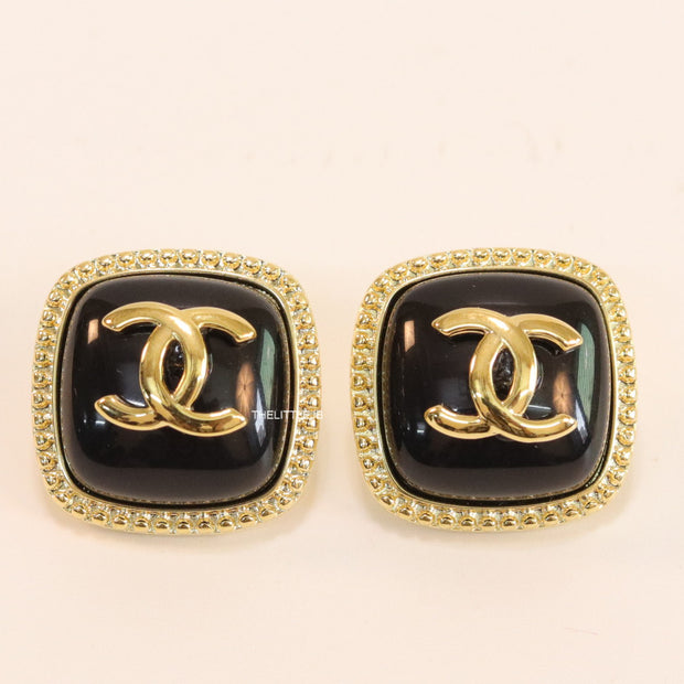 Twin C motif square studs in golden and black finish
