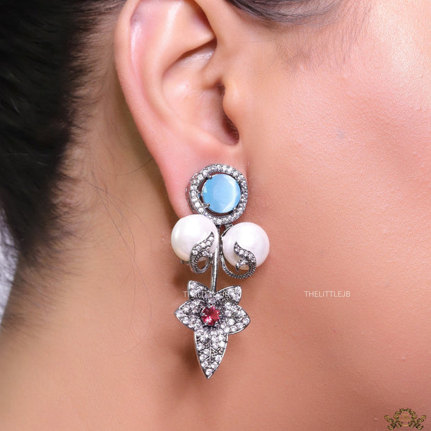 Cz flower earrings with shell pearls and light blue stones