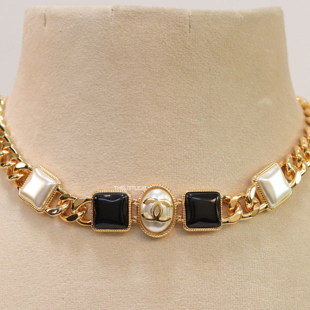 Gold plated link chain choker with MOP and black stone units.