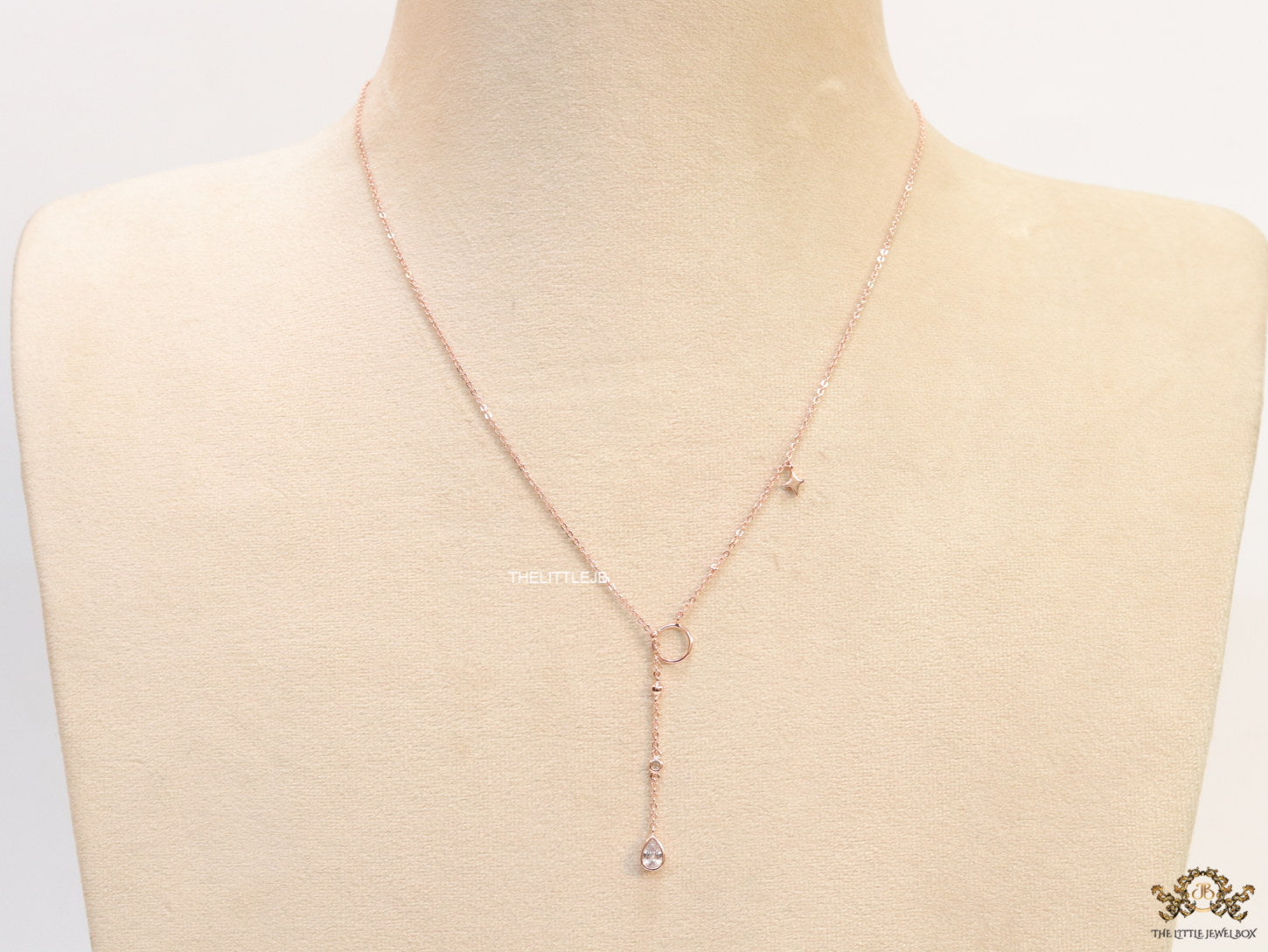 rose gold knot necklace with cz drop and small charms