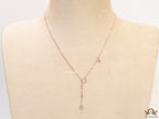 rose gold knot necklace with cz drop and small charms