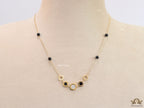 Golden chain necklace with black beads and golden alphabet discs, cz and more