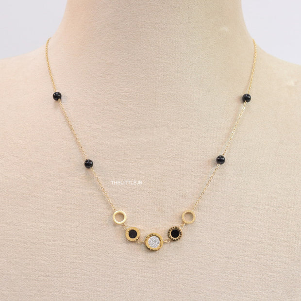 Golden chain necklace with black beads and golden alphabet discs, cz and more