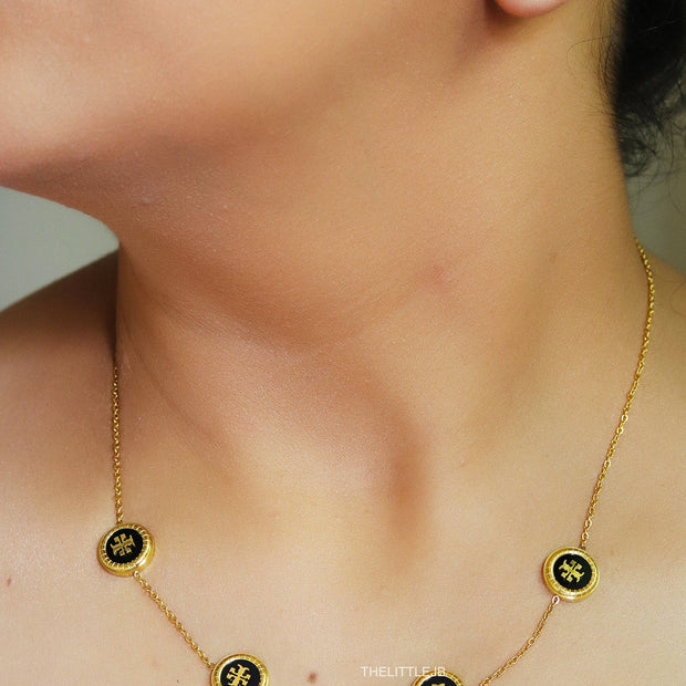 Gold plated necklace set with T motif black enamel coated discs