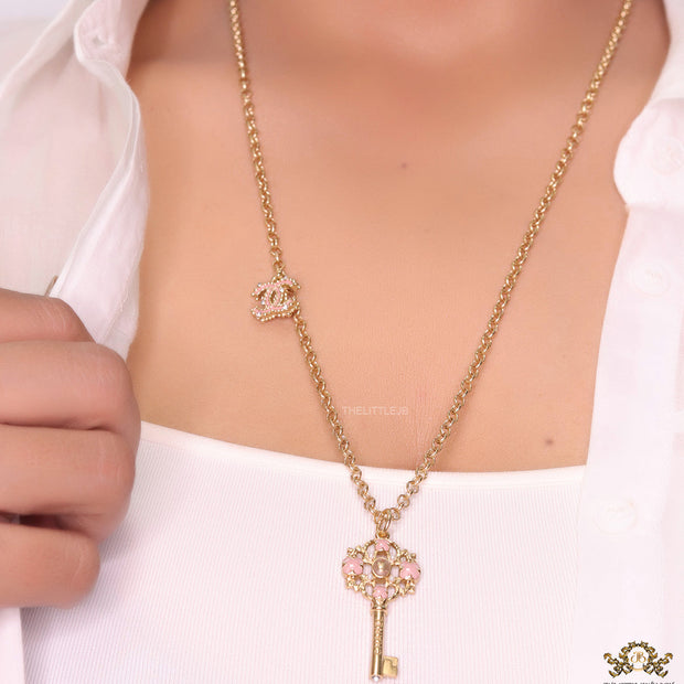 Golden chain necklace with pink clovers studded key pendant
