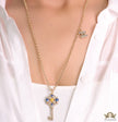Golden chain necklace with blue clovers studded key pendant