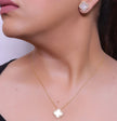 Sleek gold plated chain with cubic zirconia studded off-white clover shape pendant