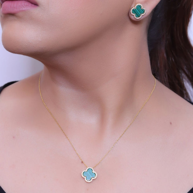Sleek gold plated chain with cubic zirconia studded green clover shape pendant