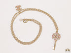 Golden chain necklace with pink clovers studded key pendant
