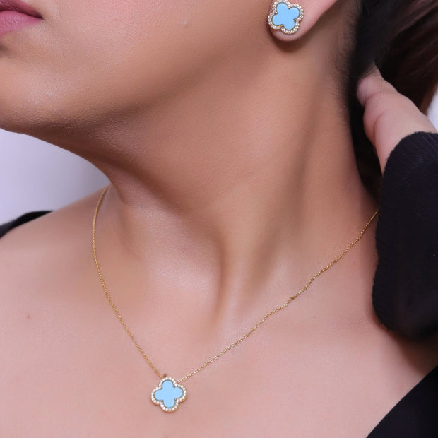 Sleek gold plated chain with cubic zirconia studded blue clover shape pendant
