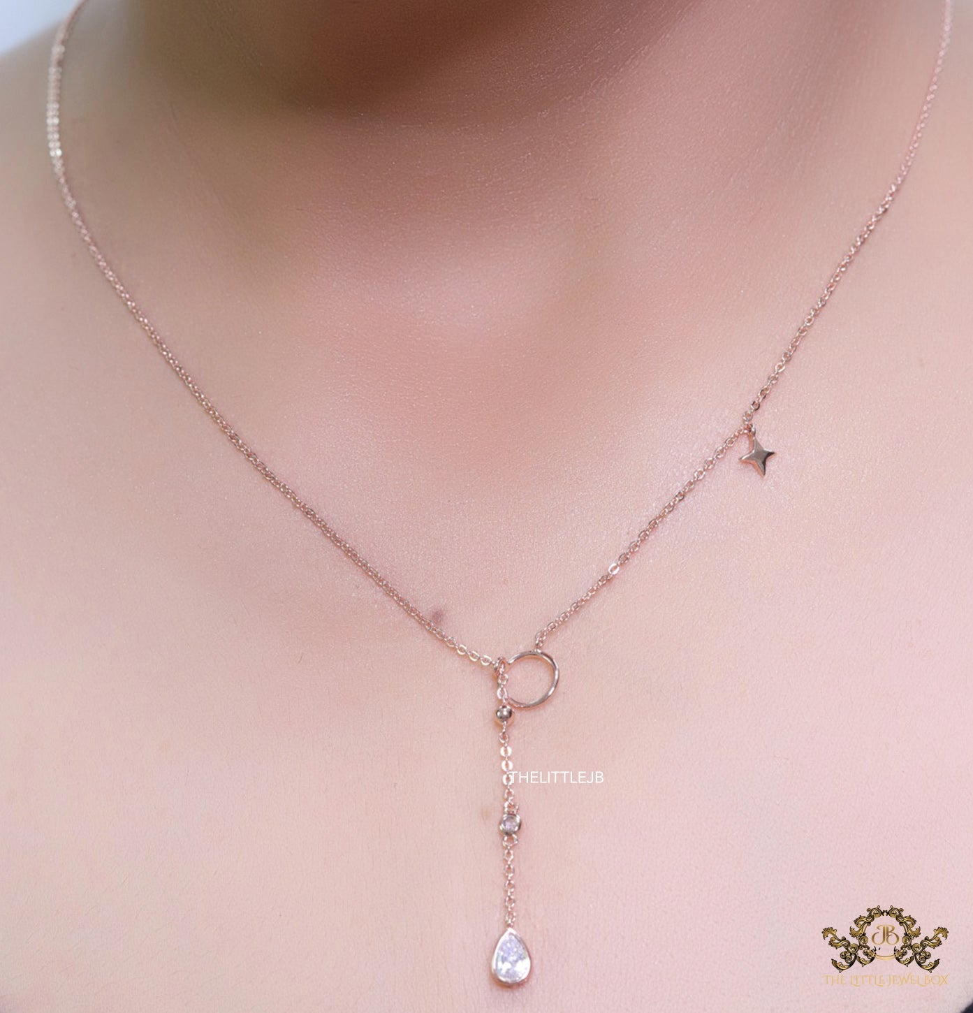 rose gold knot necklace with cz drop and small charms