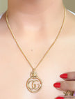 Gold plated lion face and double G initial necklace