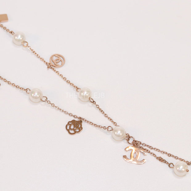 Gold chain necklace with pearls and alphabet motifs