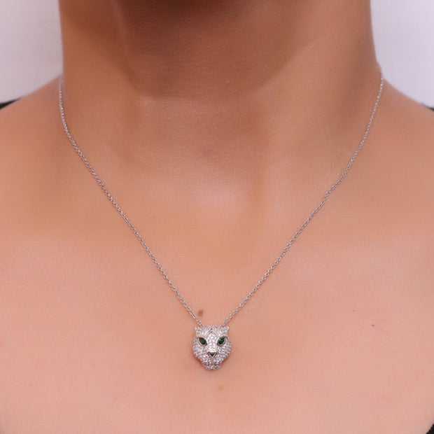 Platinum plated cubic zirconia stones panther face motif pendant with emerald green stones details on sleek Platinum plated chain