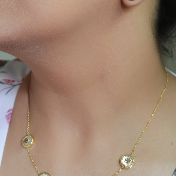 Gold plated necklace set with T motif mother of pearl discs