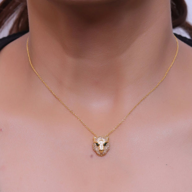 Gold plated cubic zirconia stones panther face motif pendant with emerald green stones details on sleek gold plated chain