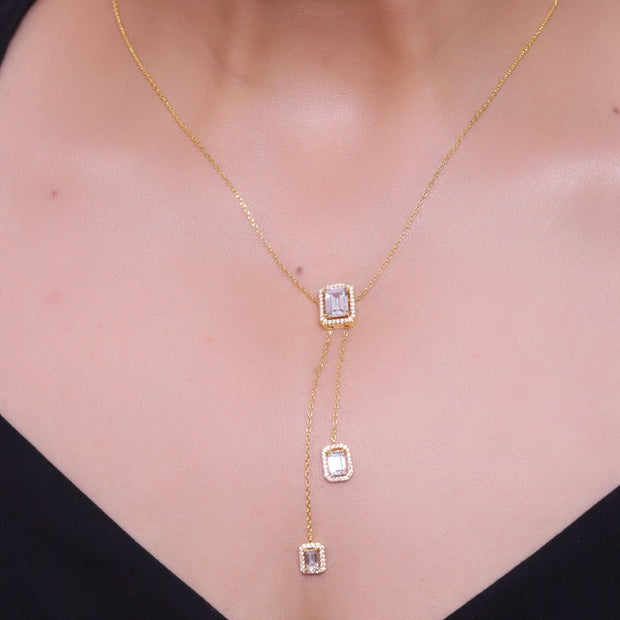 Emerald cut cubic zirconia stones in different sized on sleek gold plated chain