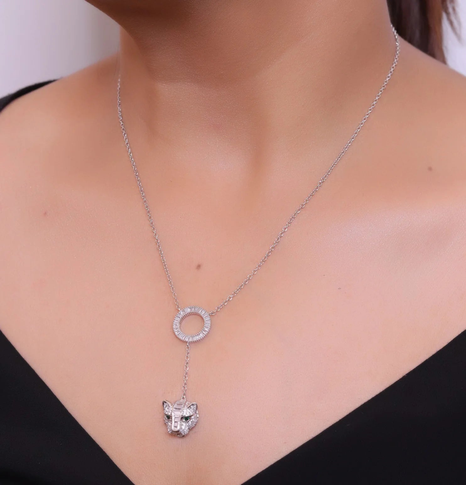 Platinum plated sleek chain with circular cubic zirconia disk and Platinum plated panther face motif pendant