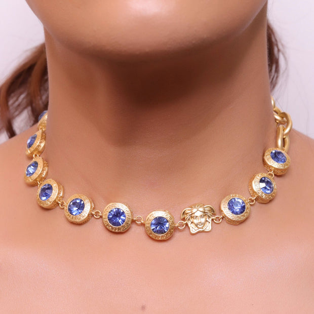 Gold plated link chain with blue cubic zirconia stones and gold plated Medusa motif charm.