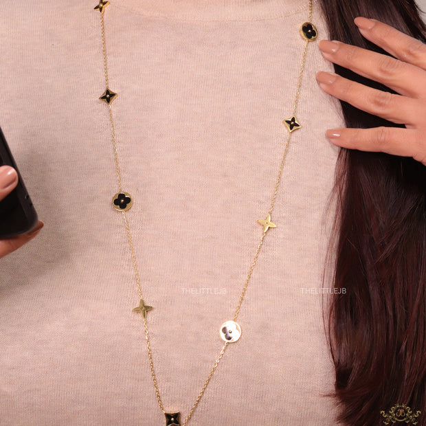 Golden chain necklace with black enamel clovers
