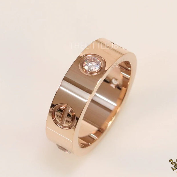 Broad 6mm rose gold band with screws and stones