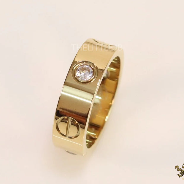 Broad 6mm gold plated band with screws and stones