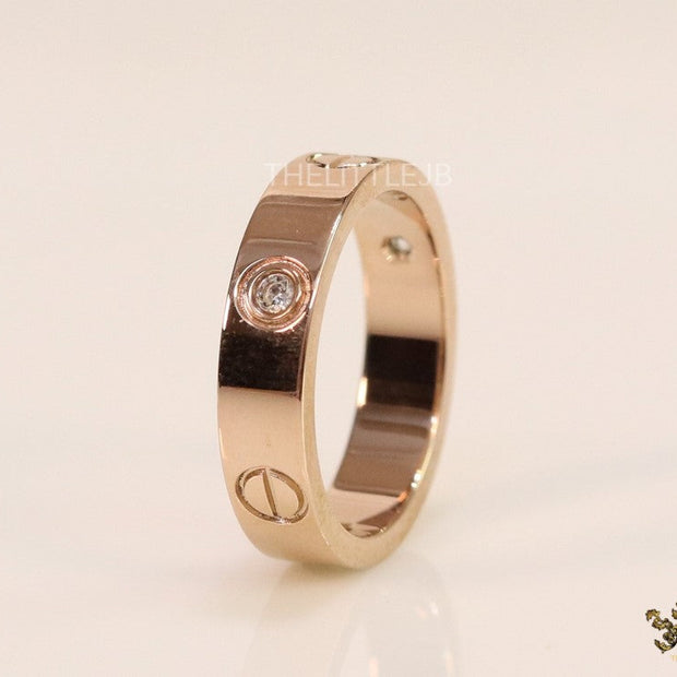 Narrow 4.5mm rose gold band with screws and stones